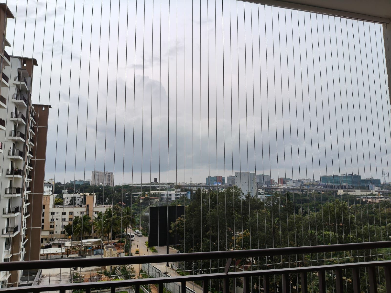 Invisible grill installed on a Bangalore apartment balcony with unobstructed city view