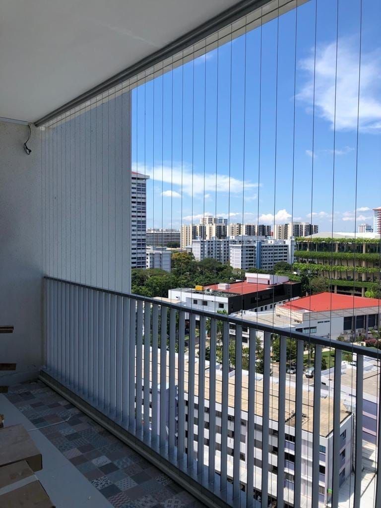 Stainless steel invisible grill installation on a high-rise residential balcony
