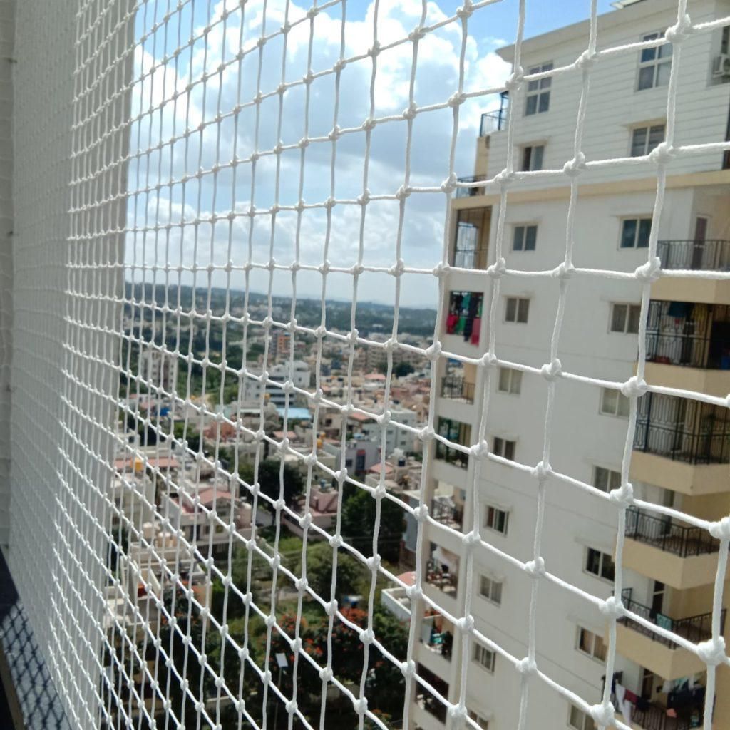 Pigeon safety net installed on a Bangalore high-rise apartment balcony